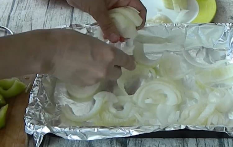 Разстелете слой лук върху листа за печене, покрит с фолио.