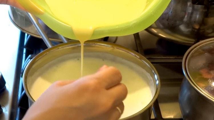 Въведете яйчена маса във врящо мляко на тънка струя.